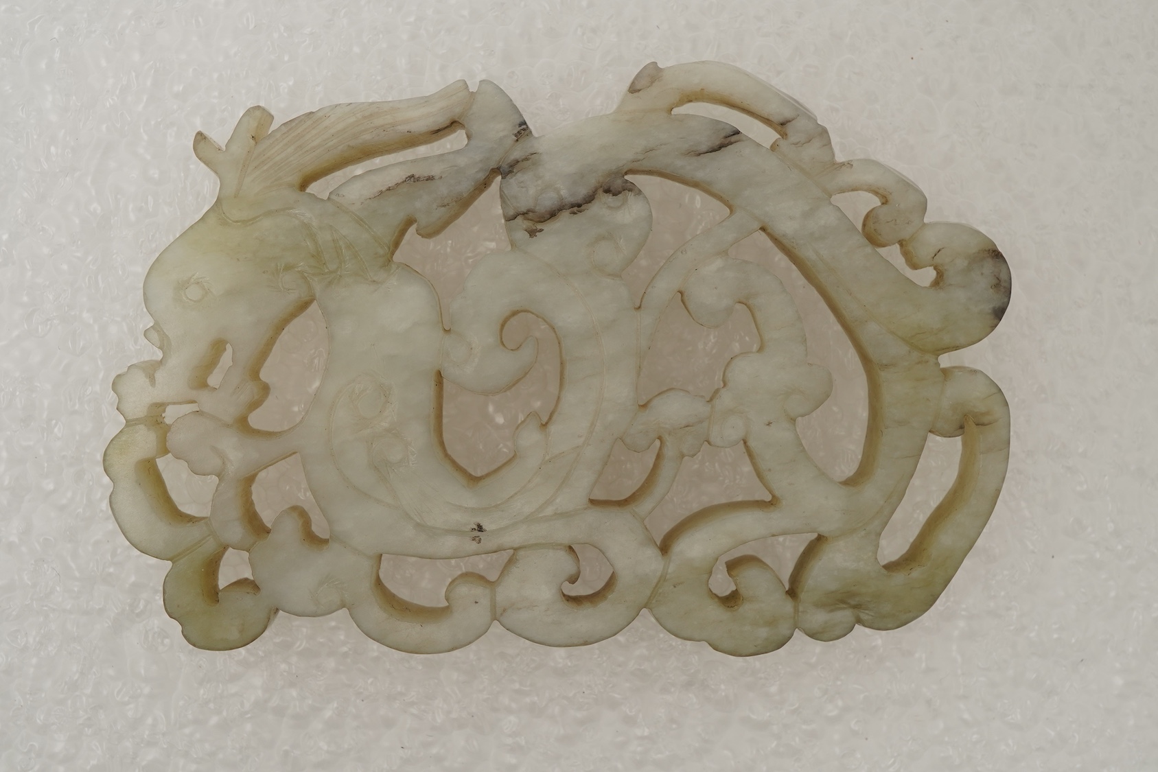 A Chinese white and grey mottled jade ‘chilong’ plaque, Ming dynasty